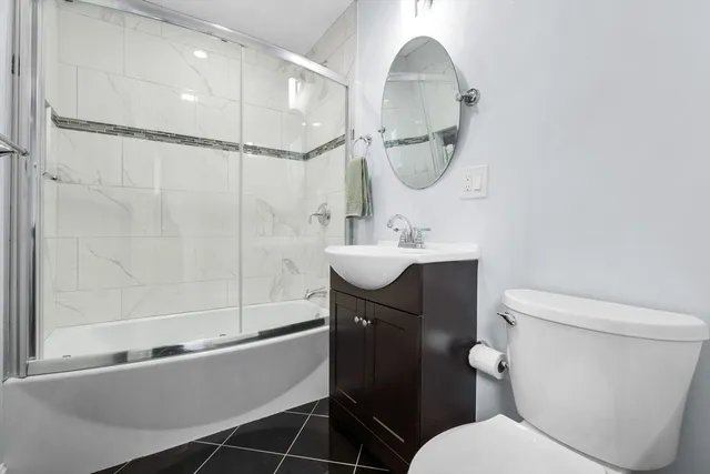 a bathroom with a sink toilet and a mirror