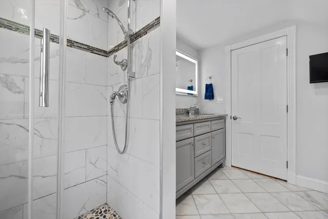 a bathroom with a shower and a sink