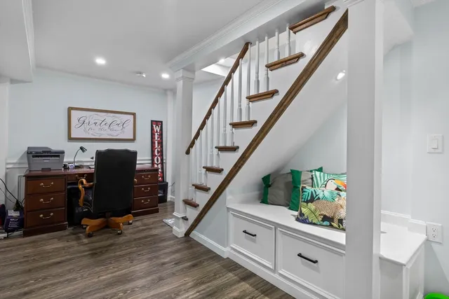 a view of a workspace with furniture and stairs