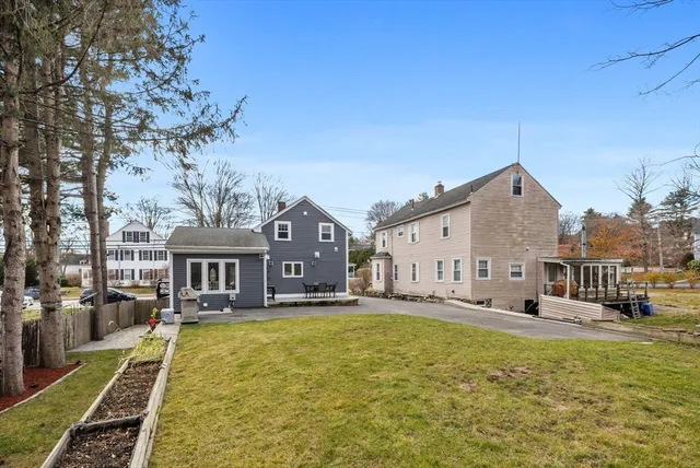 a front view of a house with swimming pool garden and outdoor seating