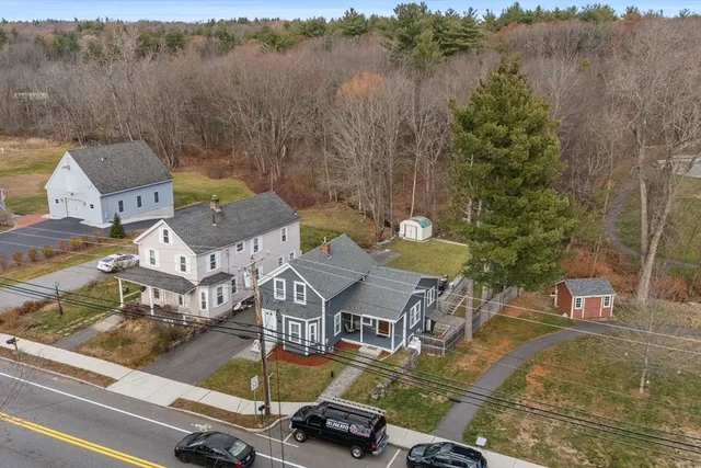 an aerial view of a house with swimming pool and lake view