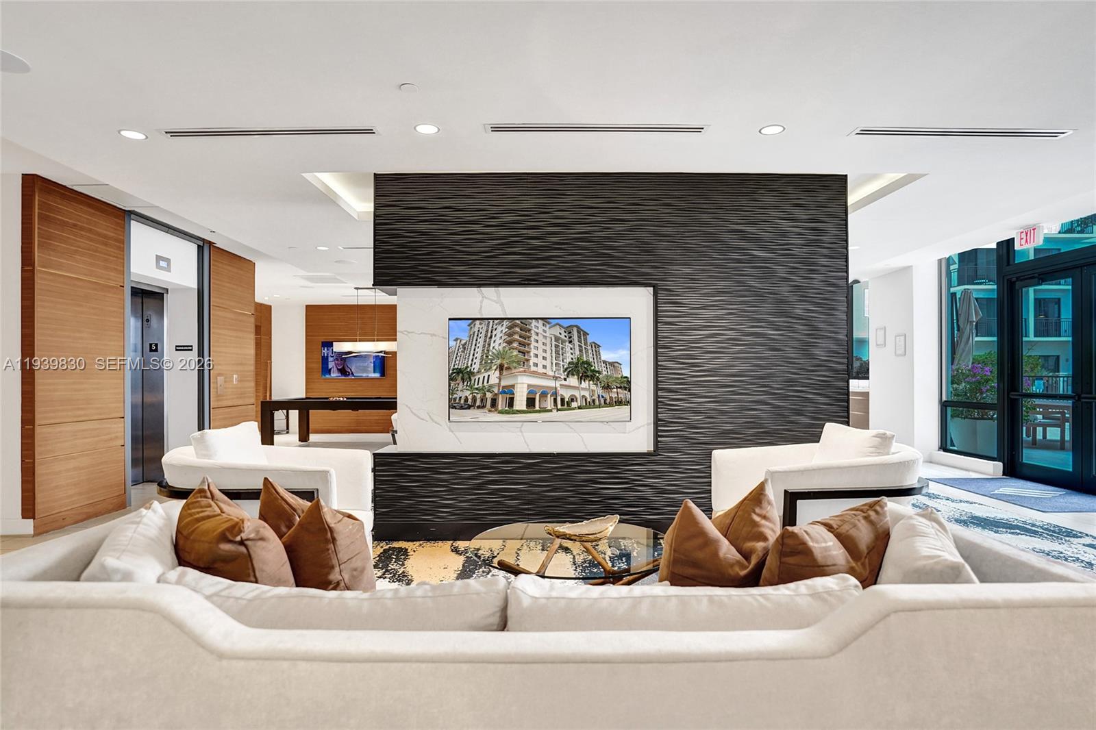 101 East Camino Real, Unit PH07 Boca Raton, FL 33432 - Photo 16 of 43 a living room with furniture and large window