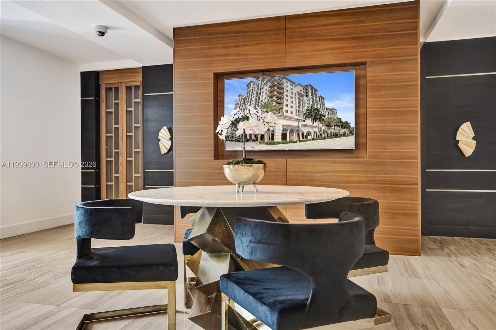 101 East Camino Real, Unit PH07 Boca Raton, FL 33432 - Photo 22 of 43 a view of a dining room with furniture wooden floor and a rug