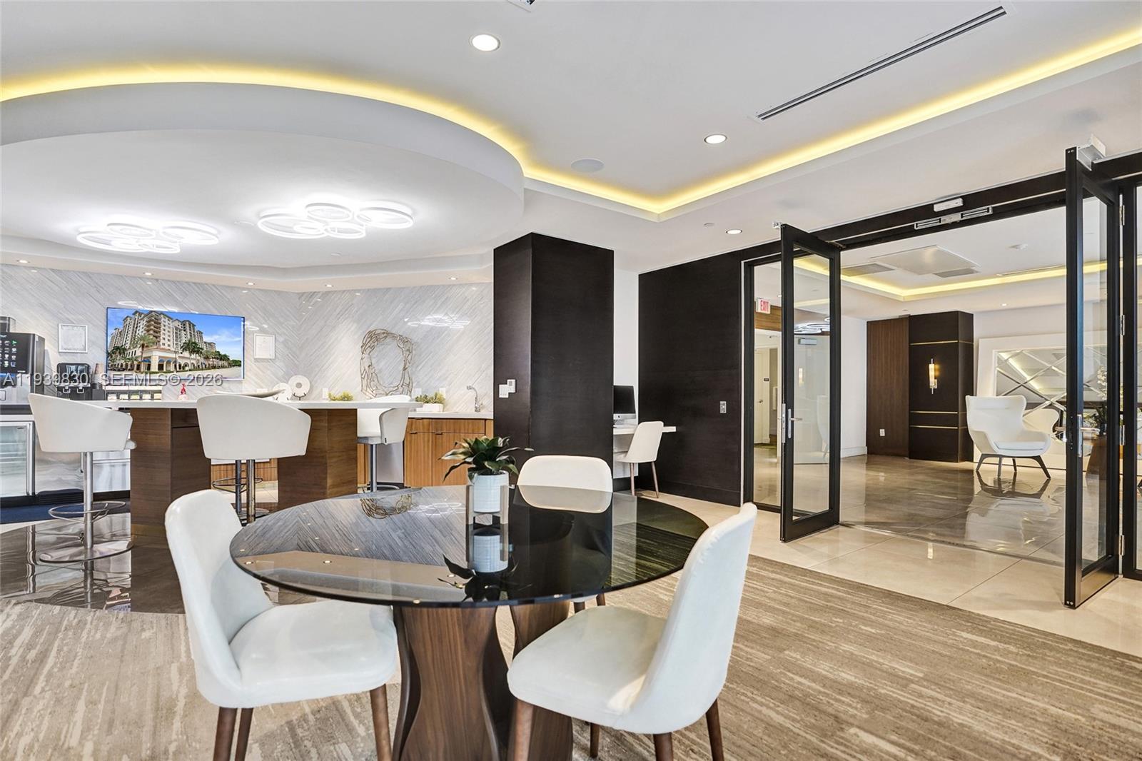 101 East Camino Real, Unit PH07 Boca Raton, FL 33432 - Photo 23 of 43 a dining room with furniture and wooden floor