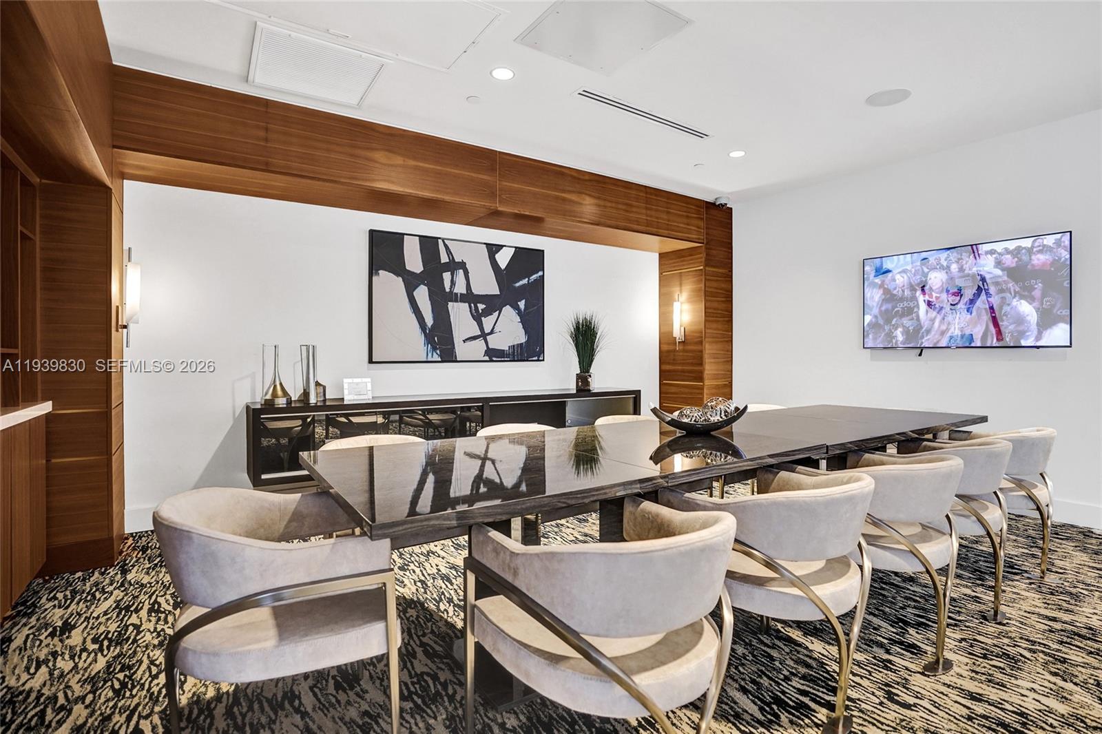 101 East Camino Real, Unit PH07 Boca Raton, FL 33432 - Photo 25 of 43 a kitchen with a table and chairs in it