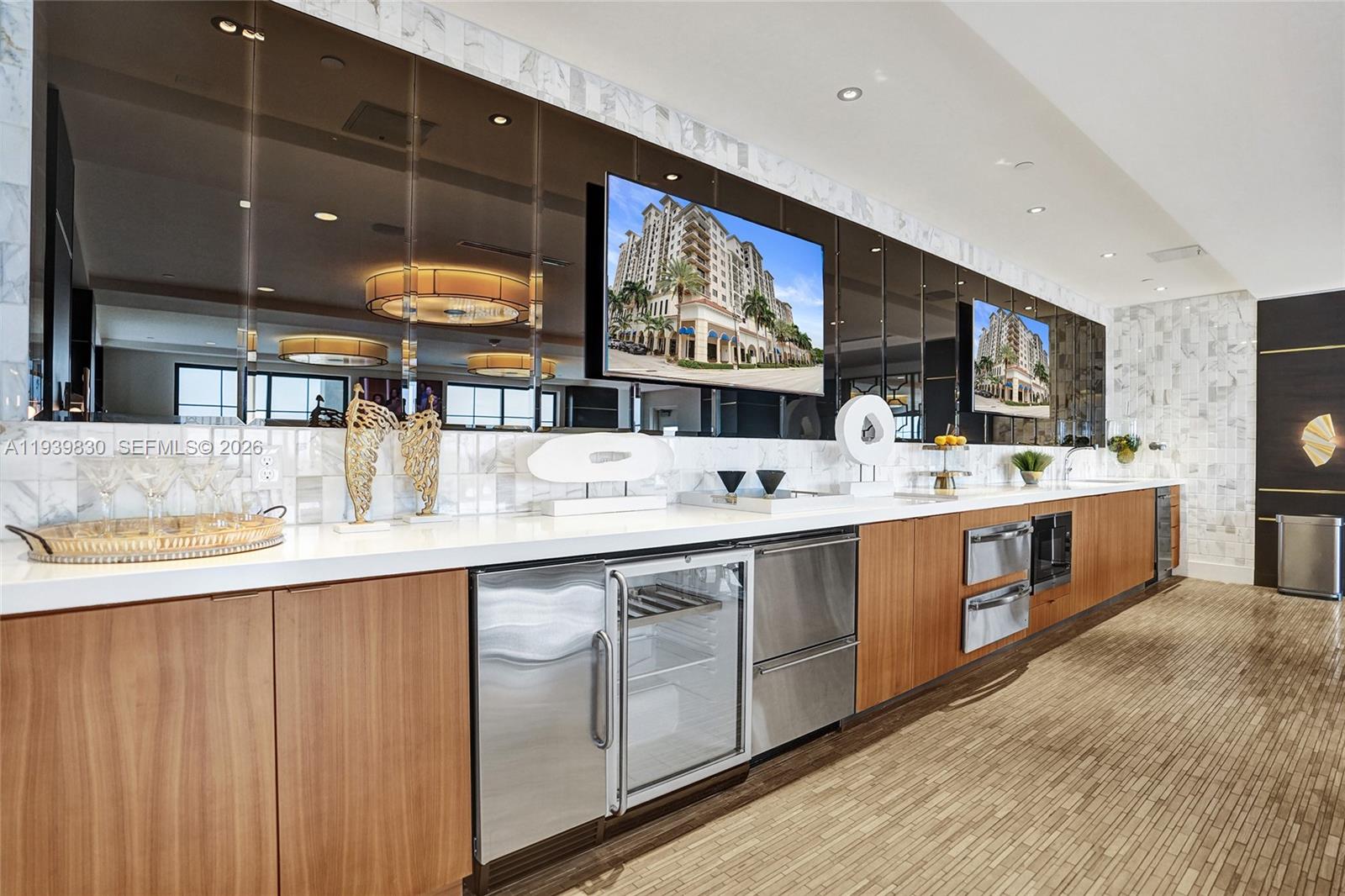 101 East Camino Real, Unit PH07 Boca Raton, FL 33432 - Photo 27 of 43 a kitchen with stainless steel appliances granite countertop a sink and cabinets