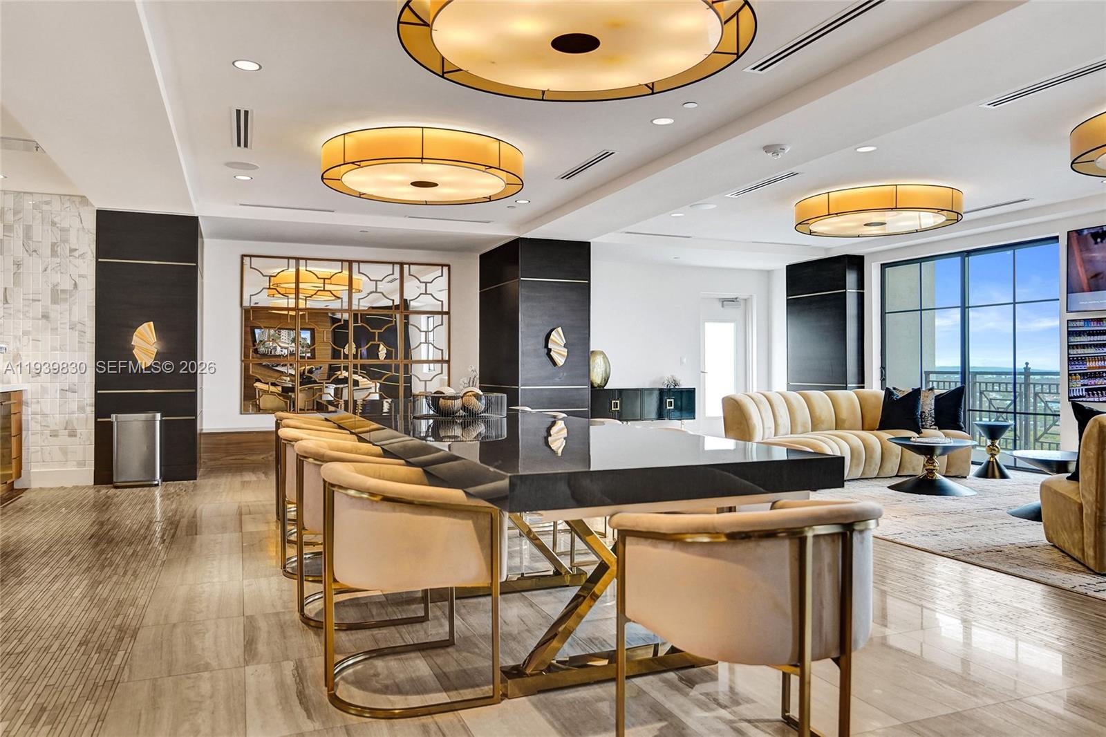 101 East Camino Real, Unit PH07 Boca Raton, FL 33432 - Photo 28 of 43 an open kitchen with dining table and chairs