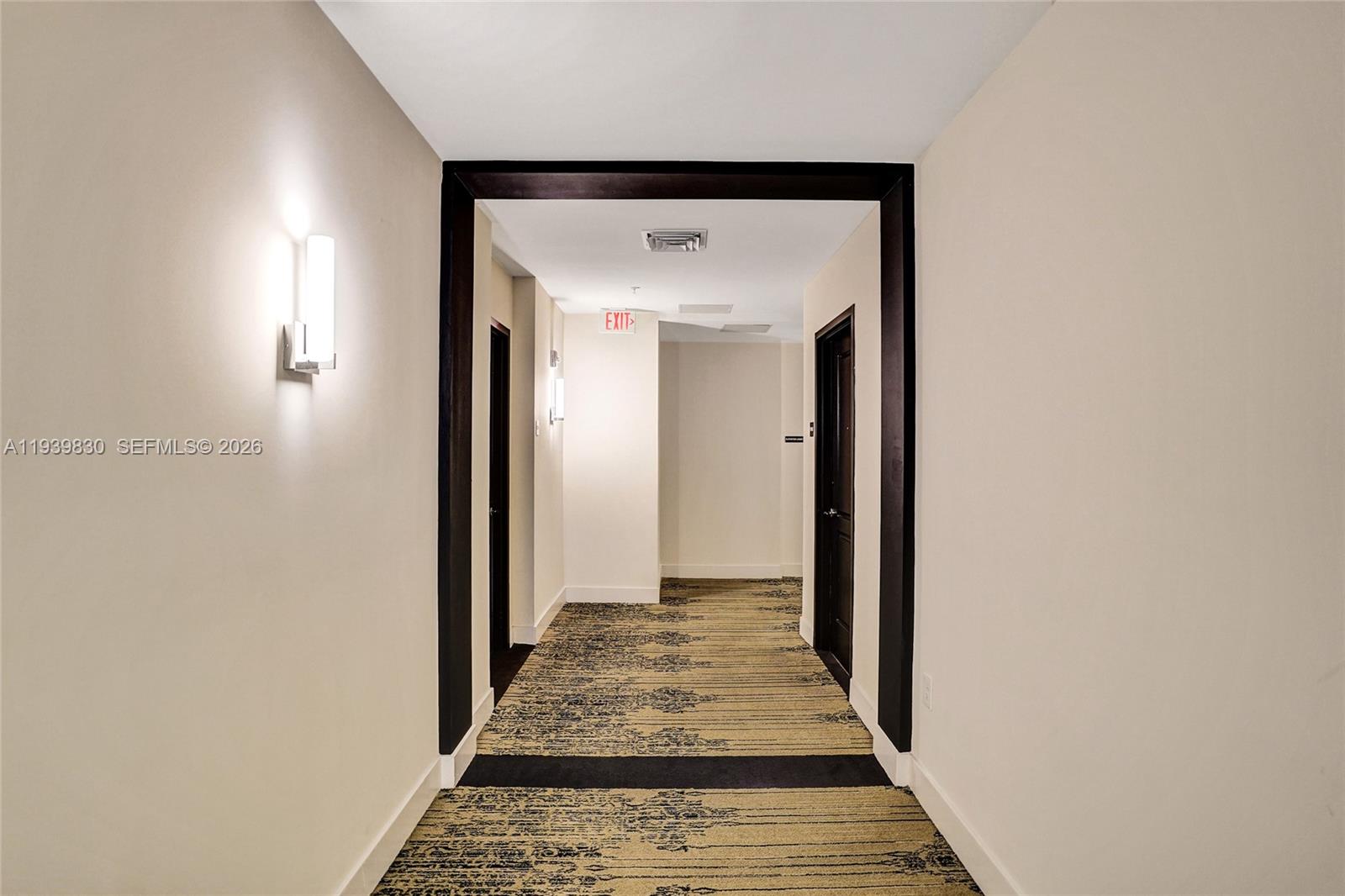 101 East Camino Real, Unit PH07 Boca Raton, FL 33432 - Photo 32 of 43 a view of a hallway with wooden floor and a bathroom