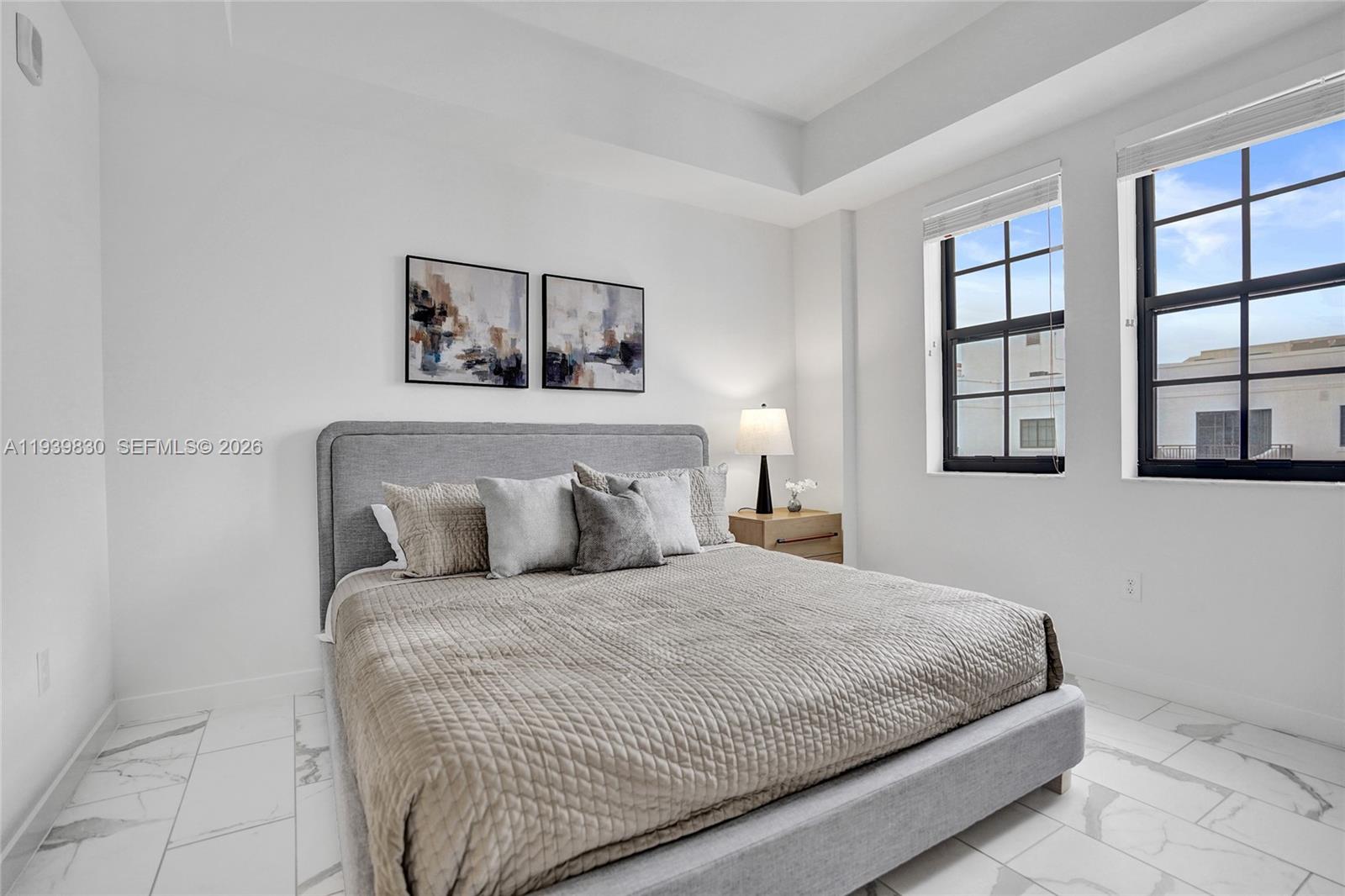 101 East Camino Real, Unit PH07 Boca Raton, FL 33432 - Photo 38 of 43 a bedroom with a large bed and a window