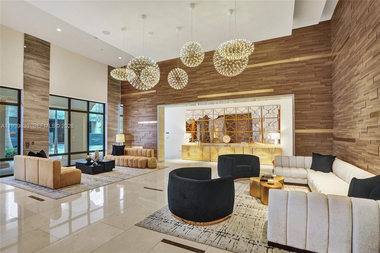 101 East Camino Real, Unit PH07 Boca Raton, FL 33432 - Photo 5 of 43 a living room with fireplace furniture and a large window