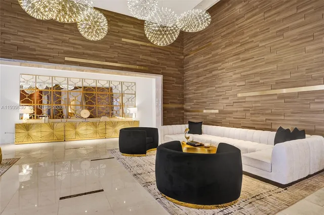 a view of a livingroom with wooden floor and a chandelier