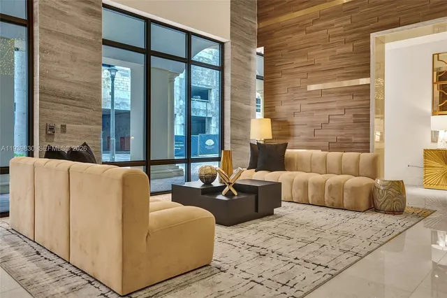 a living room with furniture a rug and a large window