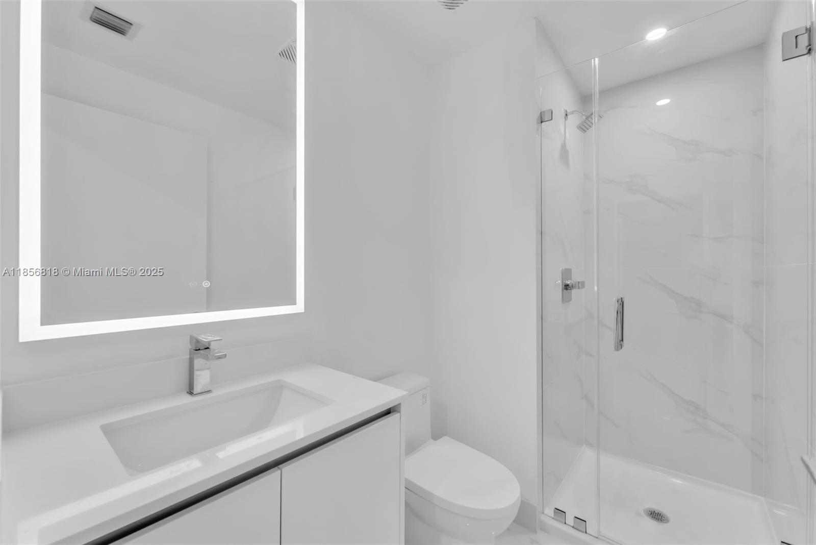 700 Northeast 24th Street, Unit 2002 Miami, FL 33137 - Photo 14 of 36 a bathroom with a sink a toilet and shower