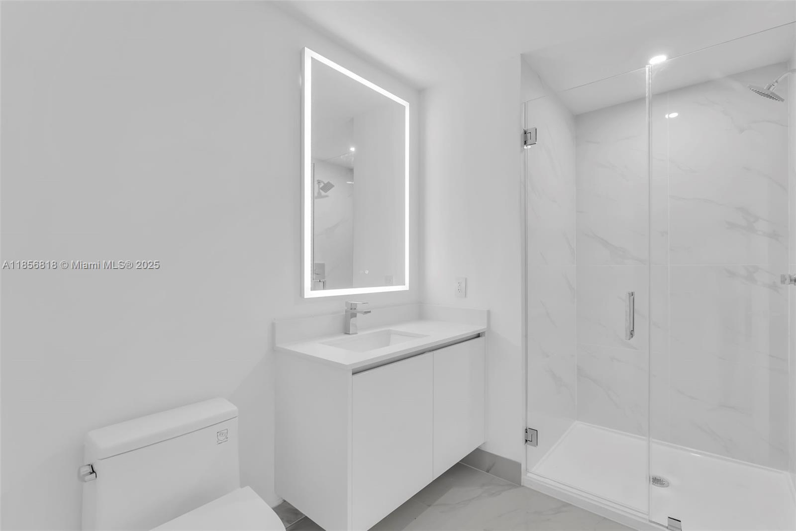 700 Northeast 24th Street, Unit 2002 Miami, FL 33137 - Photo 16 of 36 a bathroom with a sink a toilet and shower