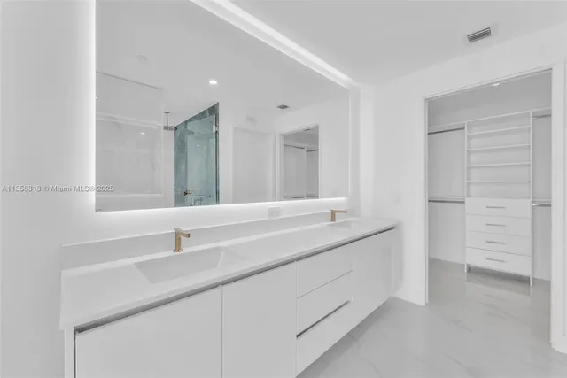 a bathroom with a double vanity sink and mirror