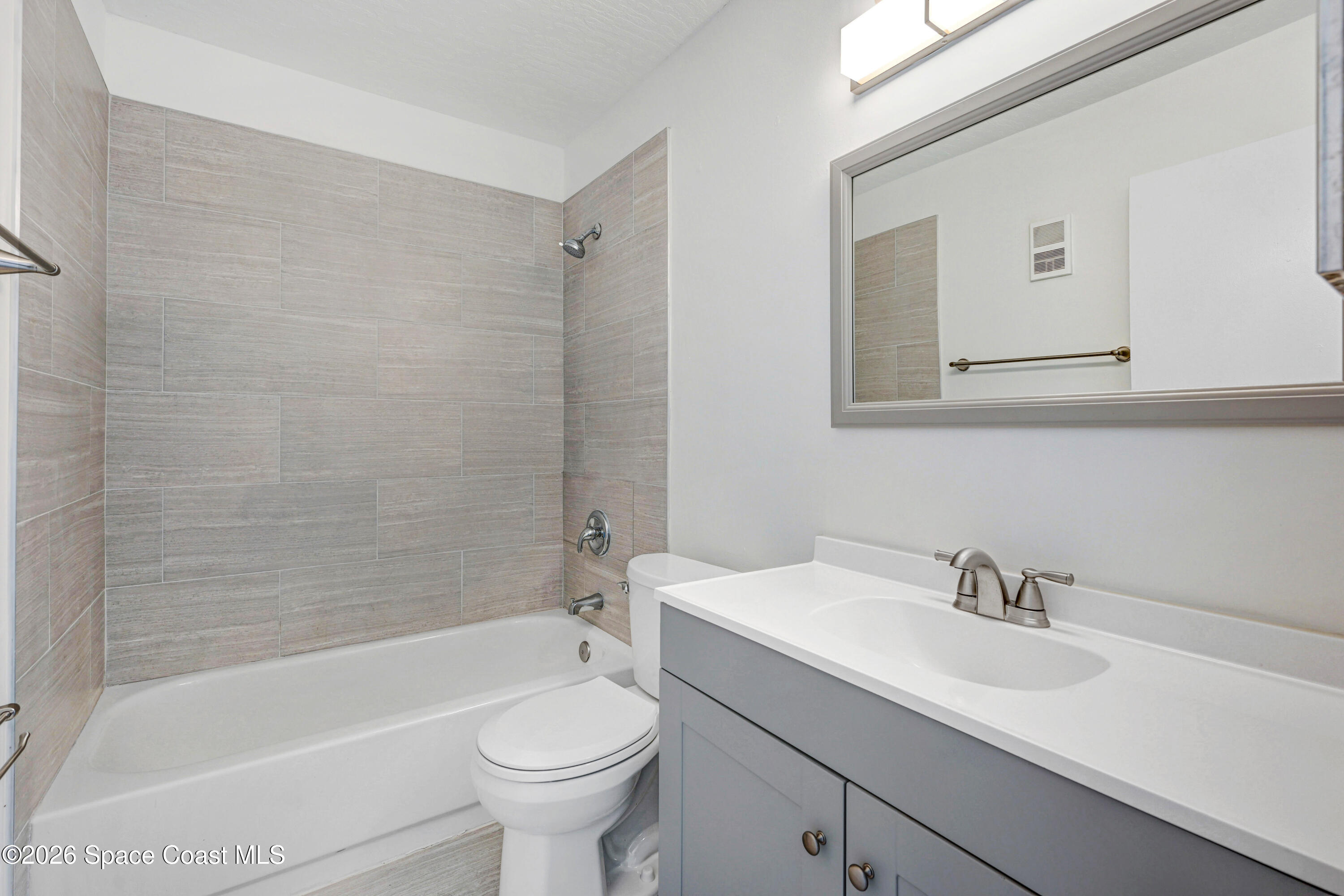 7667 North Wickham Road, Unit 1309 Melbourne, FL 32940 - Photo 12 of 21 a bathroom with a sink toilet and bathtub