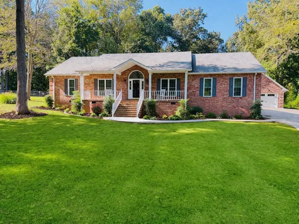 a front view of a house with a yard porch and sitting area