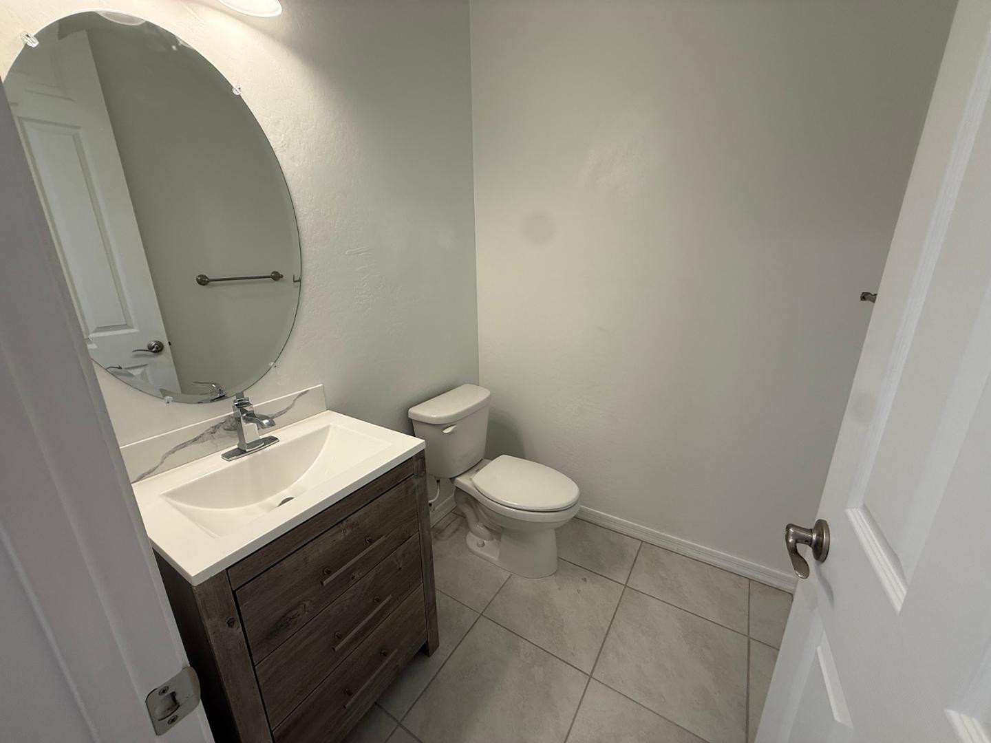 15744 West Jefferson Street Goodyear, AZ 85338 - Photo 10 of 26 a bathroom with a sink toilet and mirror