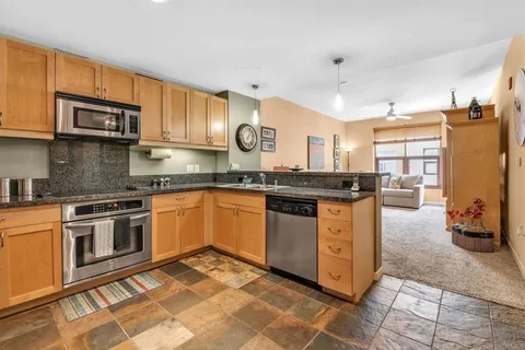 a kitchen with stainless steel appliances granite countertop a stove and a sink