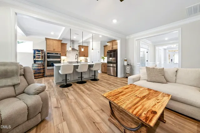 a living room with furniture ceiling fan and a fireplace