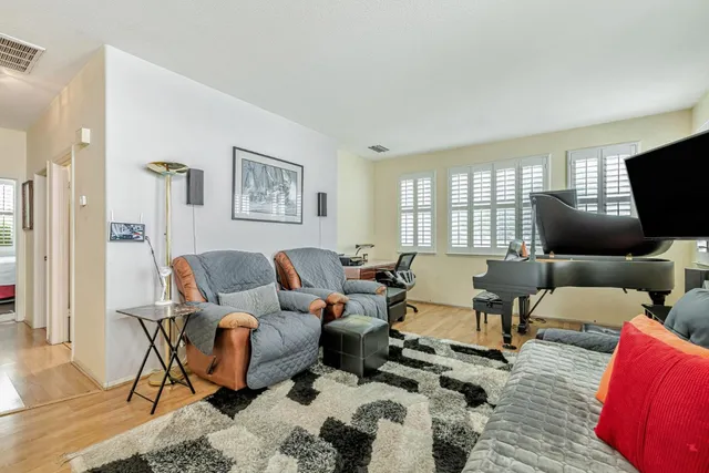 a living room with furniture kitchen view and a couch
