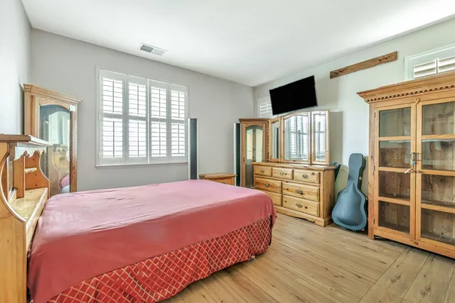 a bedroom with a bed and window
