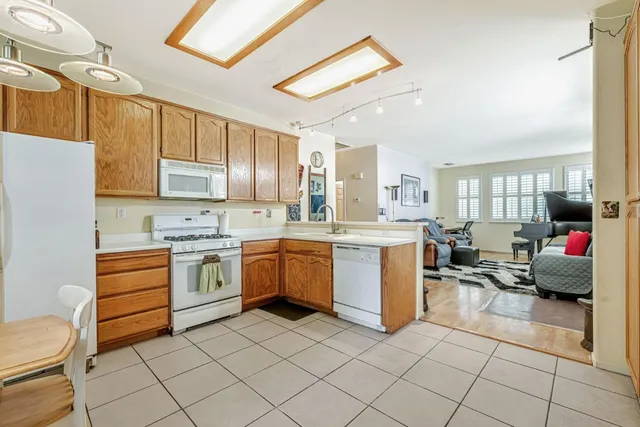 a kitchen with white cabinets and white appliances