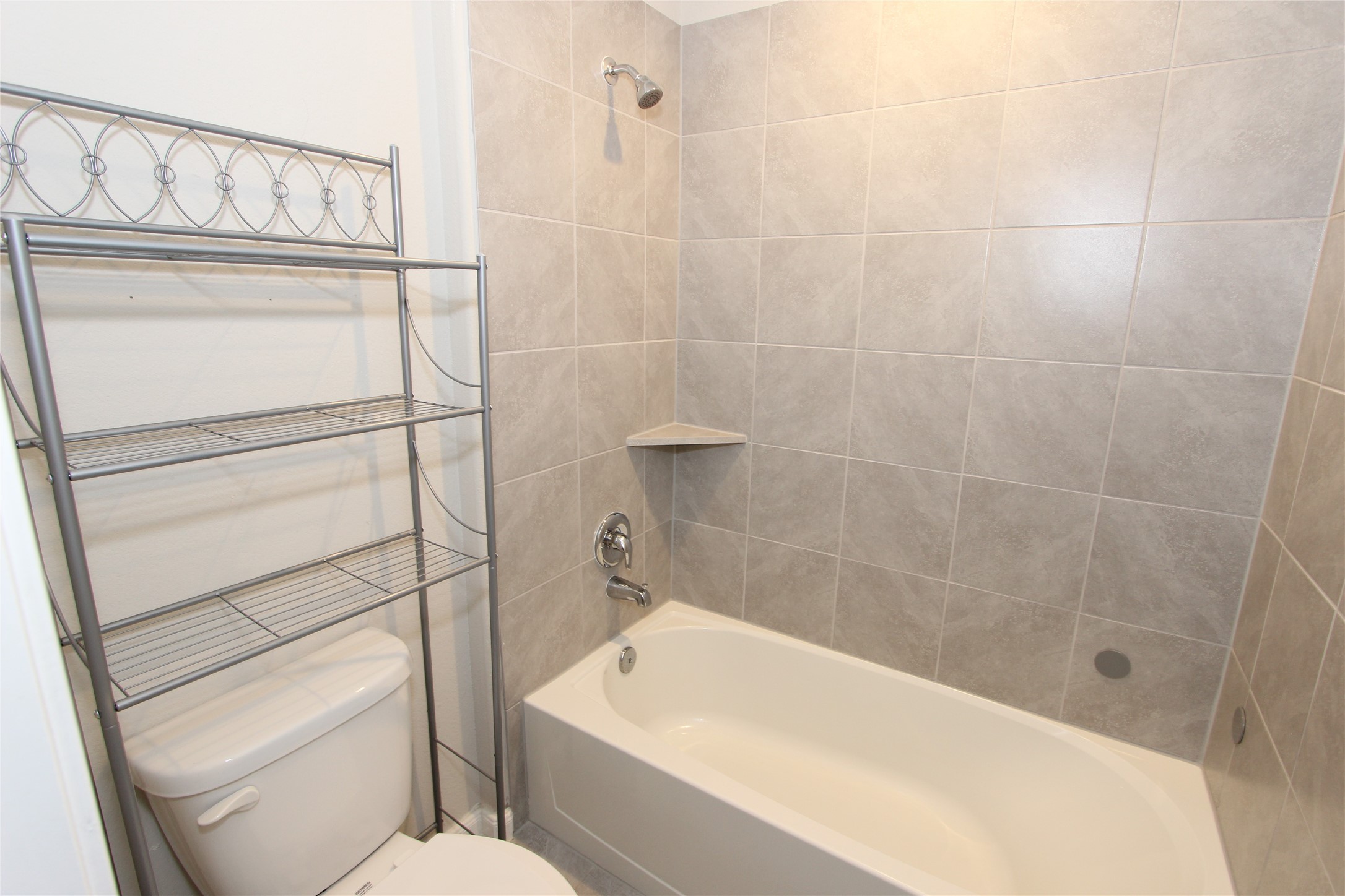 1303 Keaton Court Rosenberg, TX 77469 - Photo 15 of 22 a bathroom with a shower a toilet and sink
