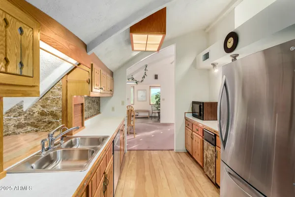 a view of a room with a stylish ceiling fan and entryway