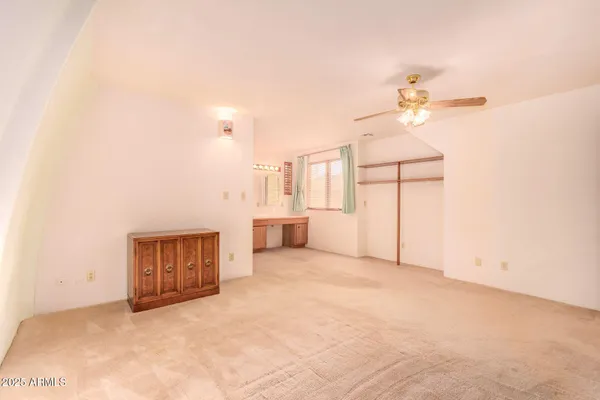 a bedroom with a bed and a night stand