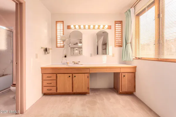 a bedroom with bed and a chair