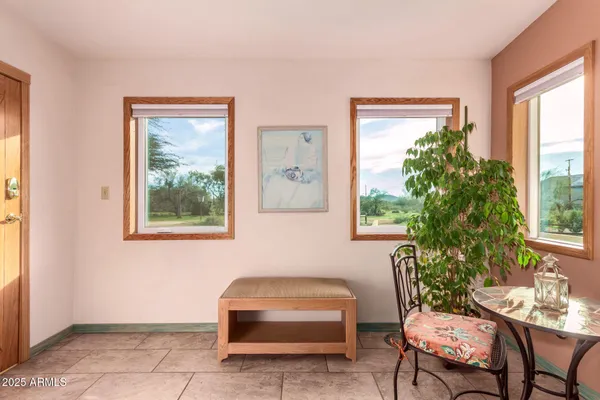 a living room with furniture and a floor to ceiling window
