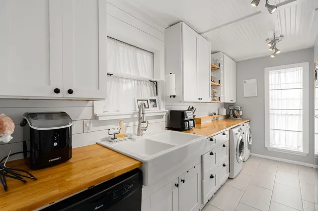 a kitchen that has a sink and a stove in it