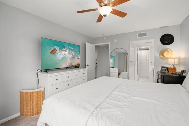 a bedroom with a bed and a flat screen tv in a dresser