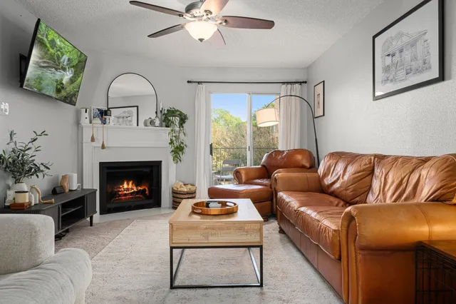 a living room with furniture ceiling fan and a fireplace