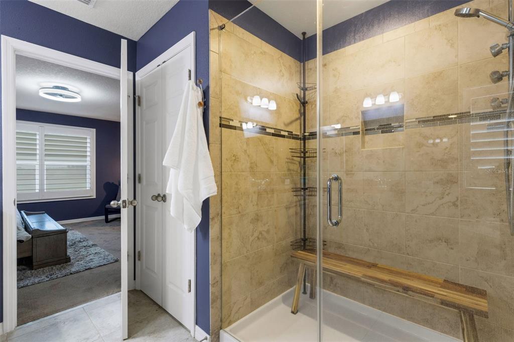 19613 Long Lake Ranch Boulevard Lutz, FL 33558 - Photo 18 of 59 a bathroom with a glass shower door and a sink