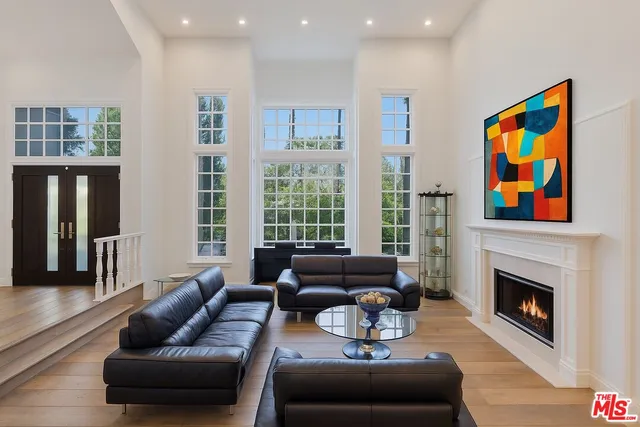 a living room with furniture fireplace and window