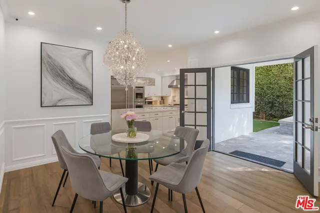 a dining room with furniture a rug and wooden floor