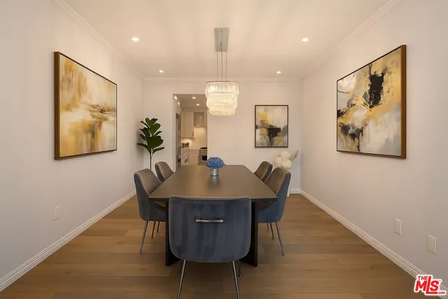 a view of a a dining room with furniture window and wooden floor