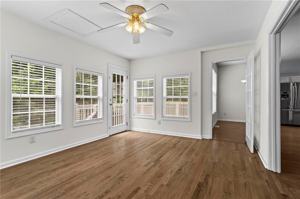 4282 Goldfield Trace, Unit MAIN & 2 Suwanee, GA 30024 - Photo 13 of 28 a view of an empty room with a window and wooden floor