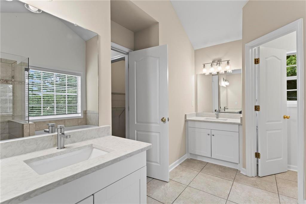 4282 Goldfield Trace, Unit MAIN & 2 Suwanee, GA 30024 - Photo 17 of 28 a bathroom with a sink and a mirror