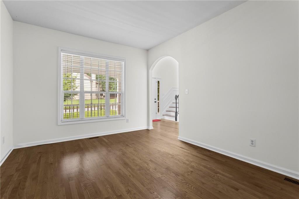 4282 Goldfield Trace, Unit MAIN & 2 Suwanee, GA 30024 - Photo 6 of 28 a view of an empty room with wooden floor and a window