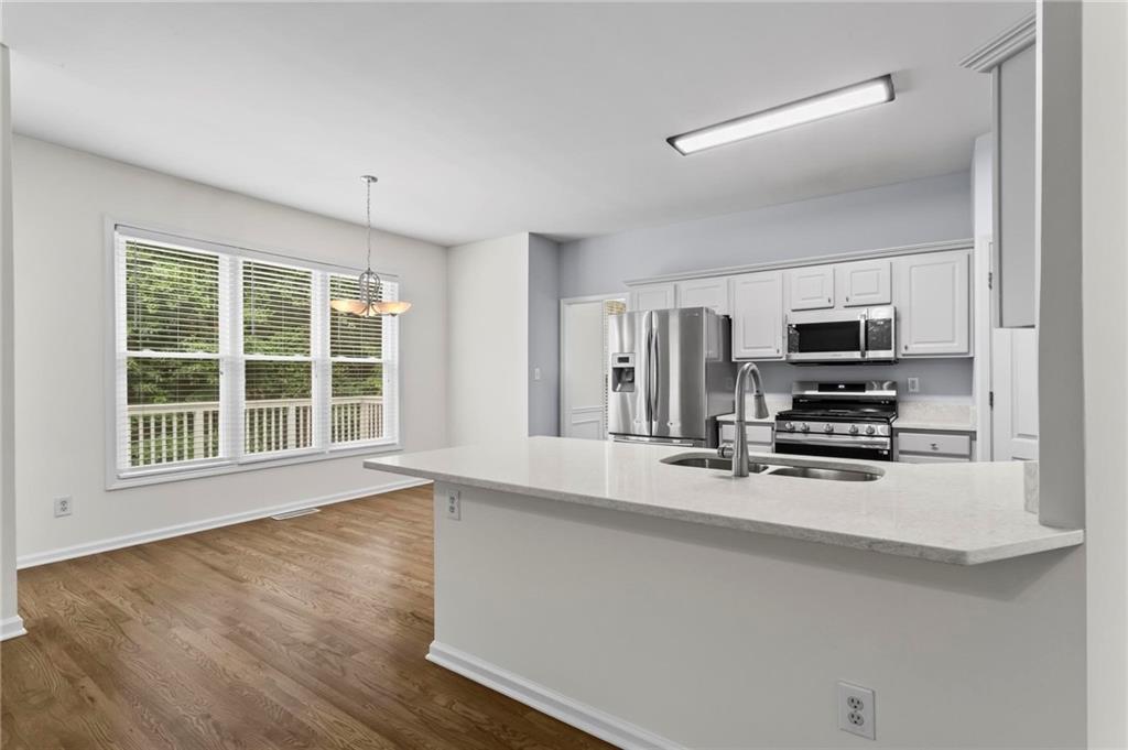 4282 Goldfield Trace, Unit MAIN & 2 Suwanee, GA 30024 - Photo 9 of 28 a kitchen with stainless steel appliances a microwave and sink