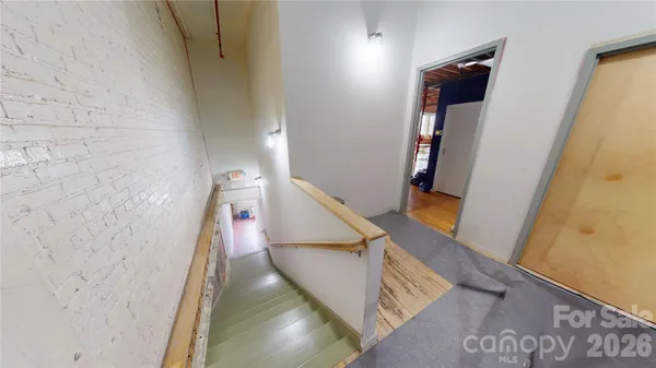 a view of a hallway with stairs