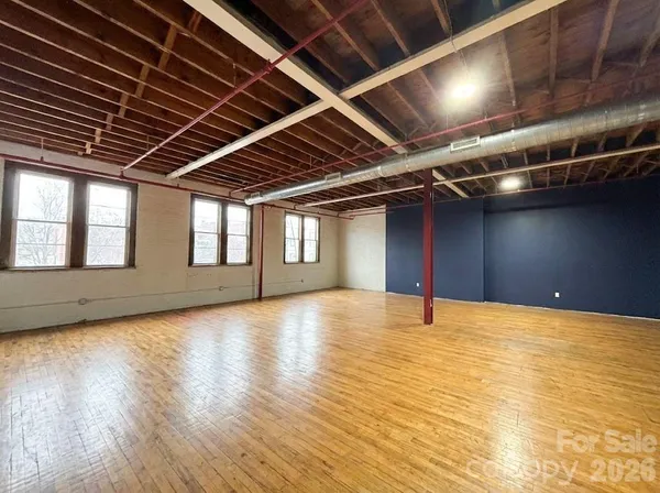 a view of an empty room with windows