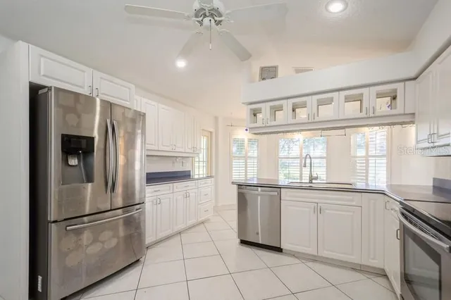 a kitchen with granite countertop a sink and a stove top oven