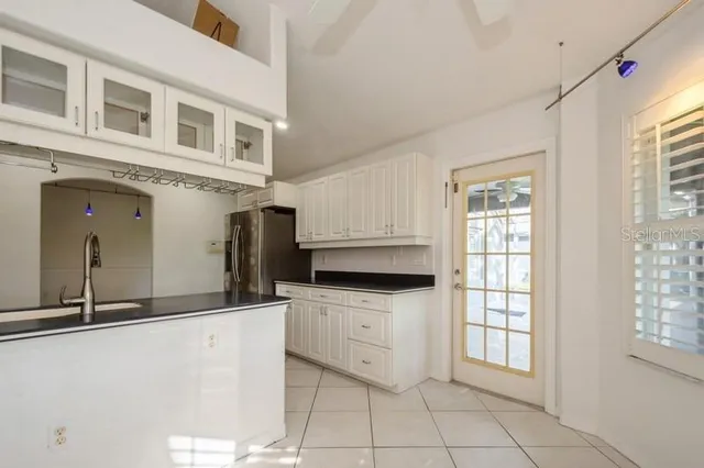 a kitchen with stainless steel appliances granite countertop a sink and cabinets