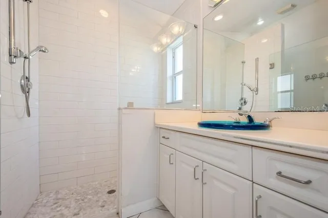 an empty room with windows and ceiling fan view