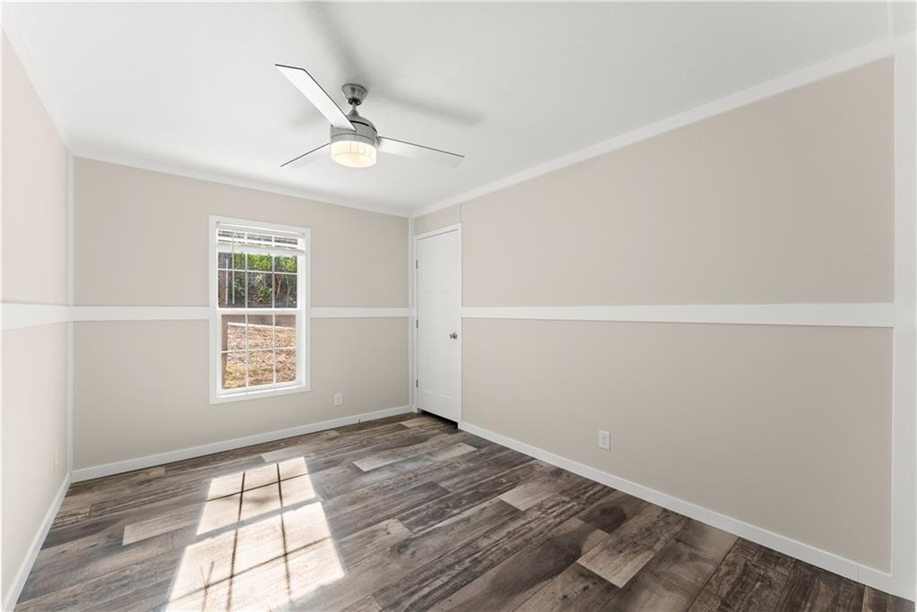 2410 Bolman Road Gainesville, GA 30507 - Photo 15 of 32 wooden floor in an empty room with a window