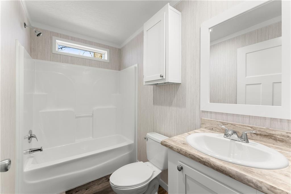 2410 Bolman Road Gainesville, GA 30507 - Photo 17 of 32 a bathroom with a granite countertop sink toilet and shower
